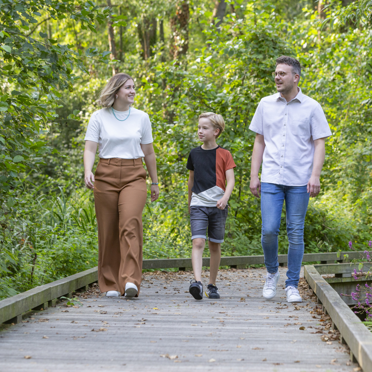 Een gezin wandelt over de vlonderplanken bij de vijver in Voerendaal