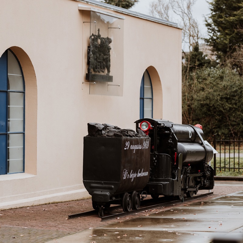 Een wagon uit het mijnverleden is geplaatst voor Schacht Nulland